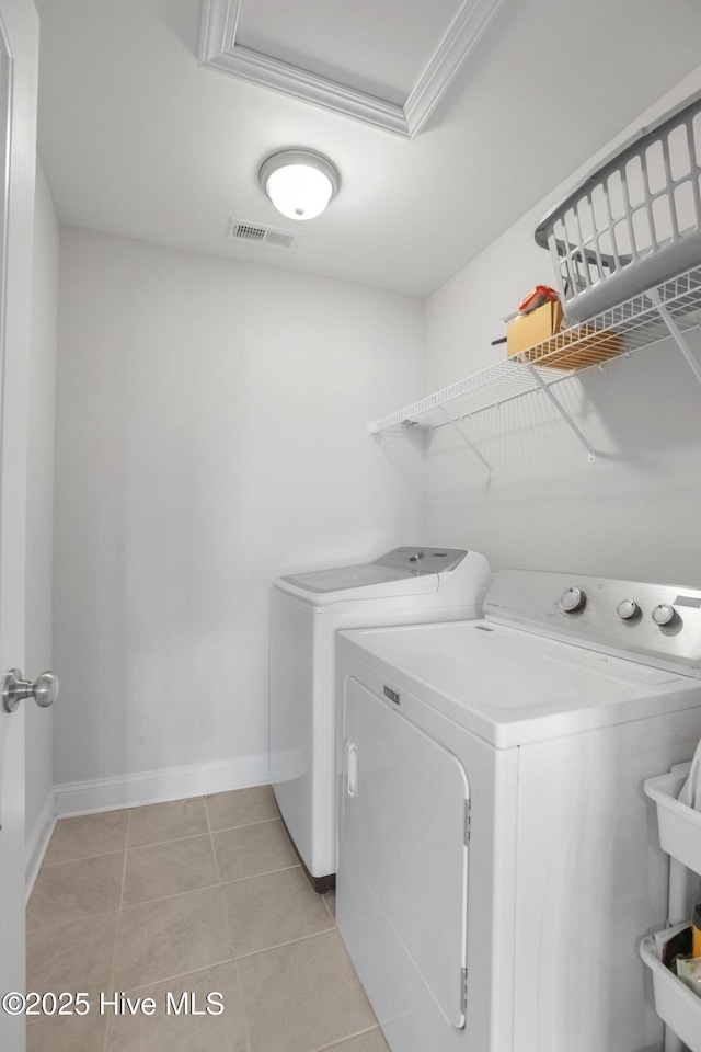 laundry area featuring laundry area, separate washer and dryer, baseboards, light tile patterned floors, and visible vents