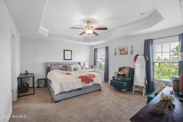 bedroom featuring carpet flooring, a ceiling fan, crown molding, and a raised ceiling