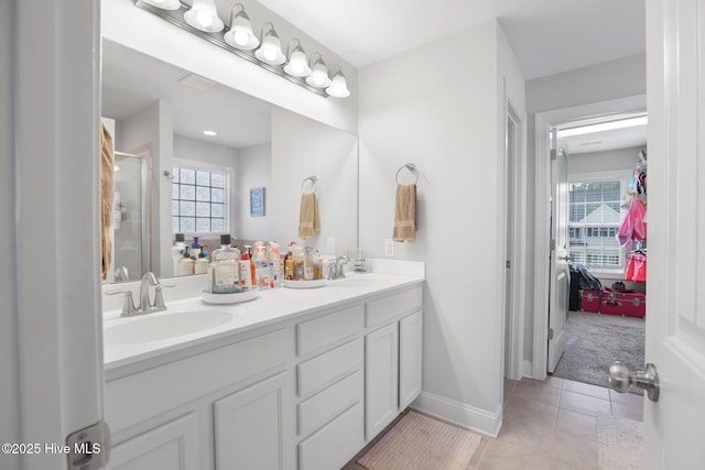 full bathroom featuring a sink, tile patterned floors, plenty of natural light, and a stall shower