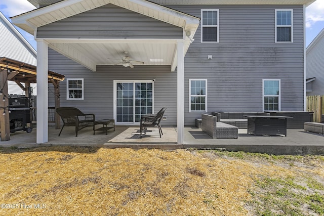 back of house featuring a gazebo, an outdoor living space, a ceiling fan, and a patio area