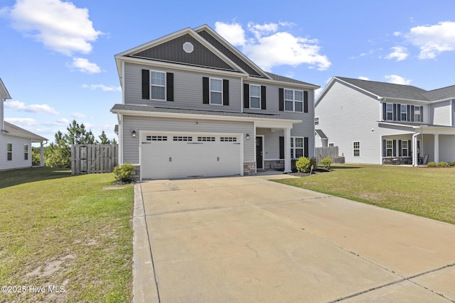 view of front of property featuring an attached garage, a front lawn, stone siding, board and batten siding, and concrete driveway