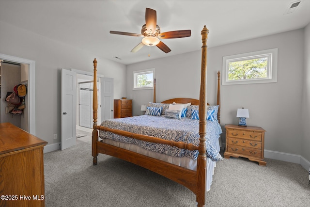 bedroom with baseboards, ceiling fan, carpet flooring, and visible vents