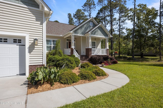 2312 Caracara Dr, New Bern, NC 28560 - view of front of house with a porch, a front lawn, and brick siding