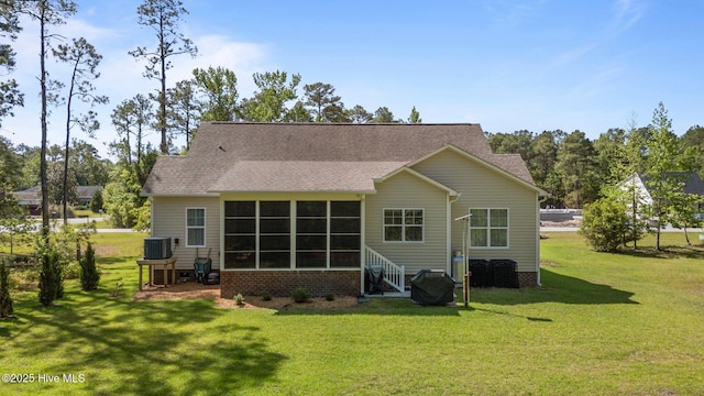 2312 Caracara Dr, New Bern, NC 28560 - rear view of house featuring central air condition unit, a yard, a shingled roof, and a sunroom