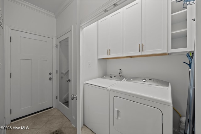 laundry area with ornamental molding, cabinet space, light tile patterned floors, and independent washer and dryer