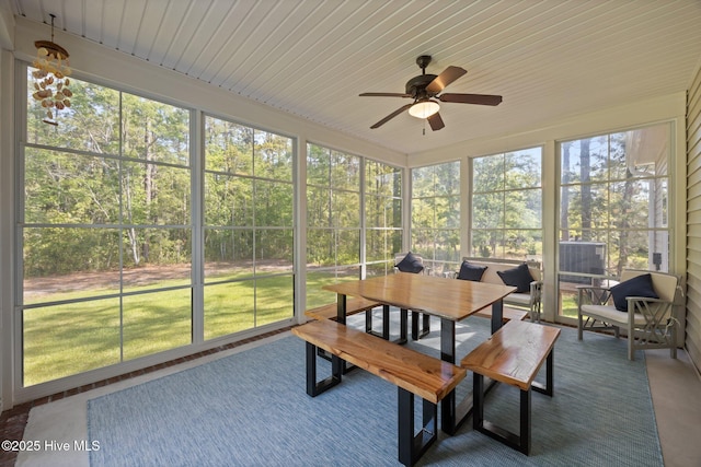 sunroom / solarium featuring a ceiling fan and outdoor dining area