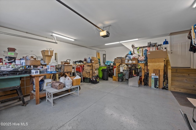 garage with a workshop area and a garage door opener