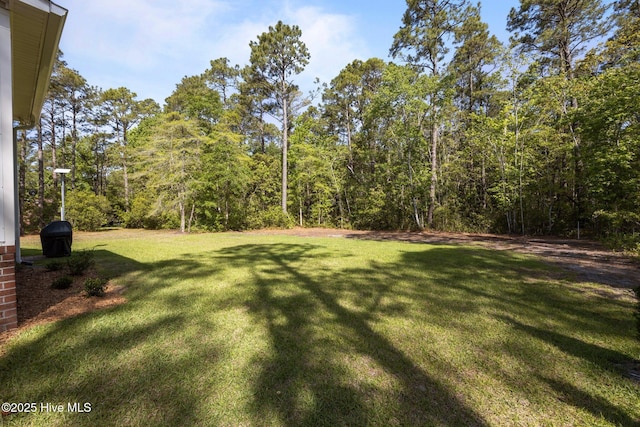 view of yard featuring a view of trees