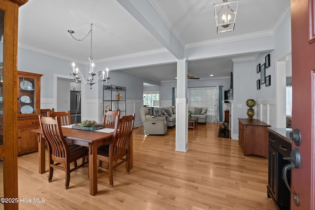 2312 Caracara Dr, New Bern, NC 28560 - dining space with a chandelier, light wood finished floors, crown molding, wainscoting, and a decorative wall