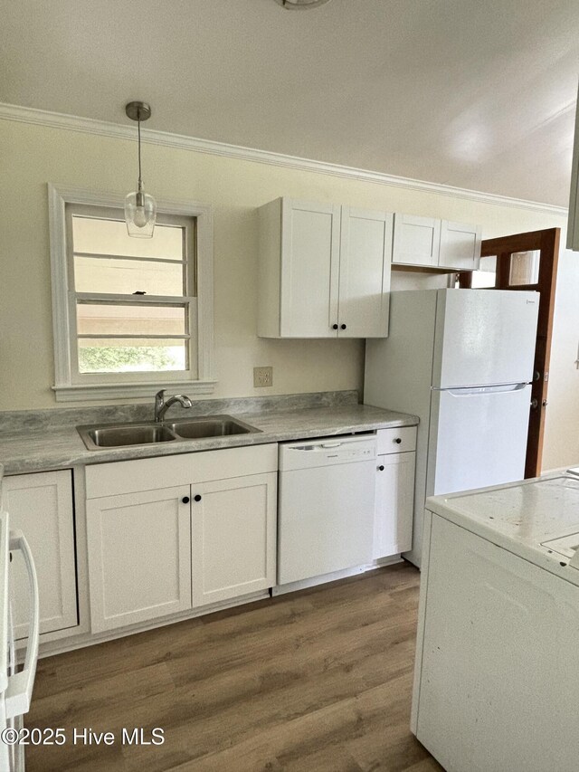 115 Cherry St, Woodland, NC 27897 - kitchen with white cabinets, a sink, ornamental molding, white appliances, and hanging light fixtures