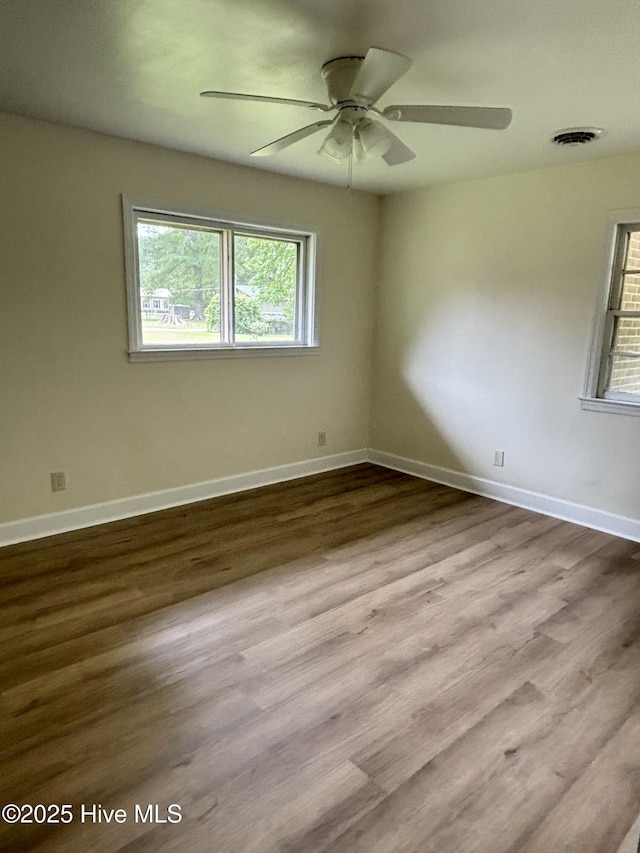 115 Cherry St, Woodland, NC 27897 - empty room featuring baseboards, visible vents, wood finished floors, and a ceiling fan