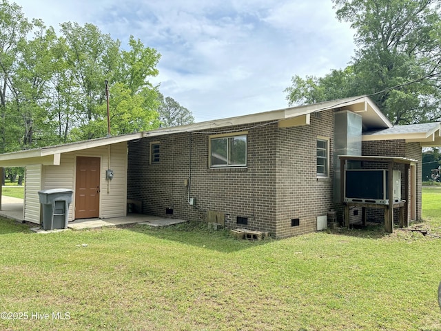 115 Cherry St, Woodland, NC 27897 - rear view of house featuring a lawn, crawl space, and brick siding