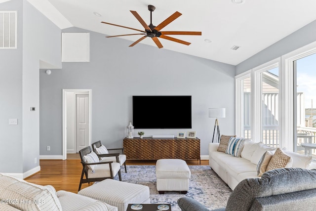 living room featuring ceiling fan, visible vents, plenty of natural light, and high vaulted ceiling