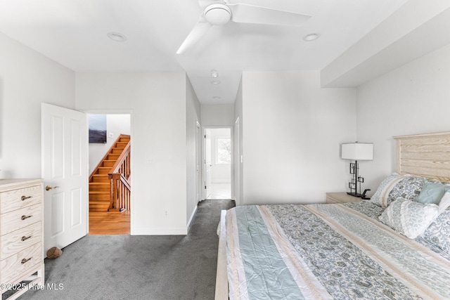 bedroom with ceiling fan, baseboards, and carpet