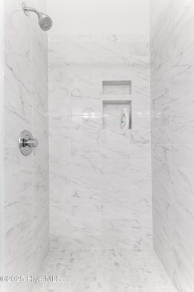 full bathroom with tiled shower