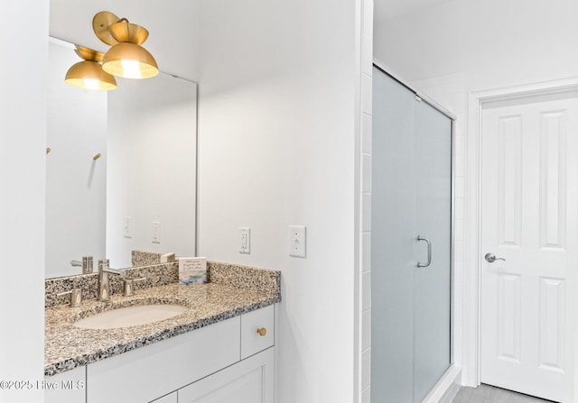 bathroom with vanity and a stall shower