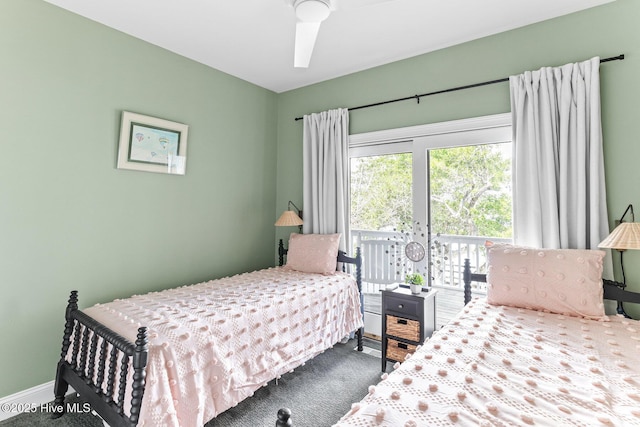 carpeted bedroom featuring baseboards and access to outside