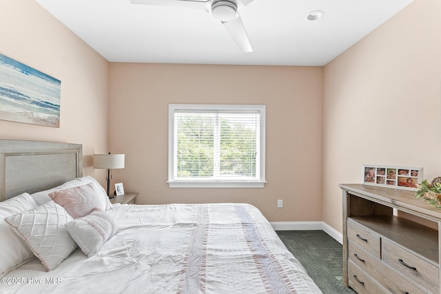 bedroom with baseboards, ceiling fan, and dark colored carpet