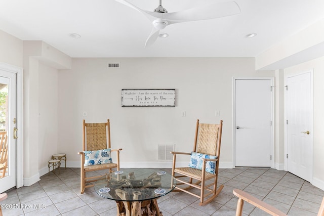 living area featuring light tile patterned floors and visible vents