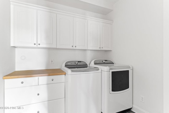 laundry room featuring washer and clothes dryer and cabinet space