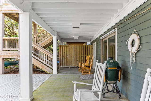 view of patio / terrace featuring a deck and stairs