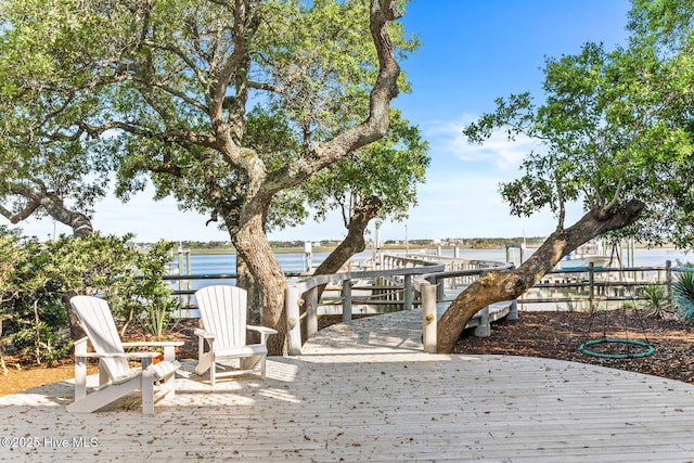 wooden terrace featuring a water view