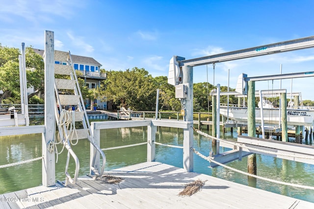 view of dock with boat lift and a water view