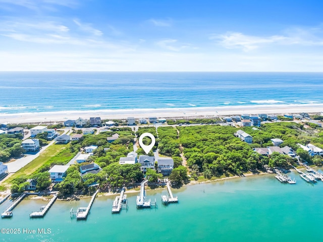 drone / aerial view with a water view and a beach view