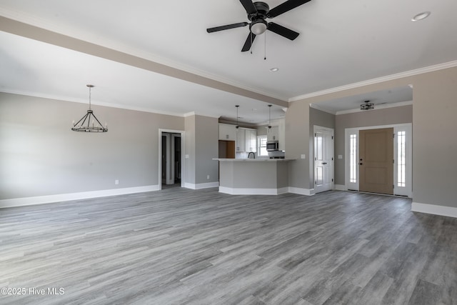 unfurnished living room featuring light wood finished floors, a ceiling fan, baseboards, and ornamental molding