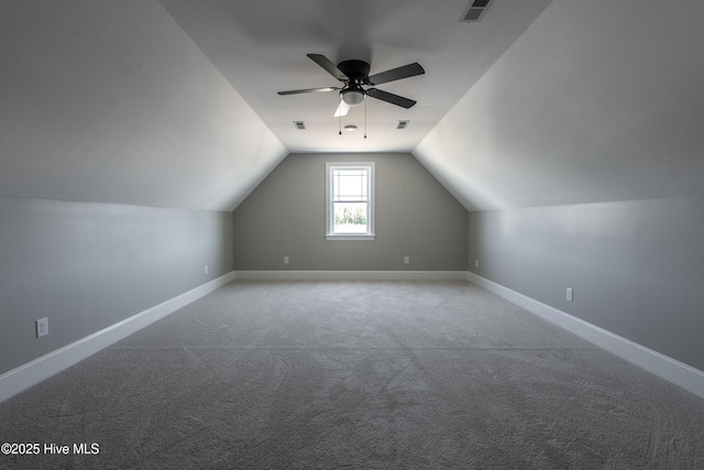 additional living space featuring vaulted ceiling, visible vents, carpet floors, and ceiling fan