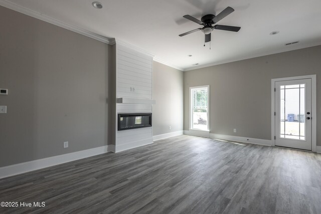 unfurnished living room featuring wood finished floors, ceiling fan, a fireplace, baseboards, and visible vents