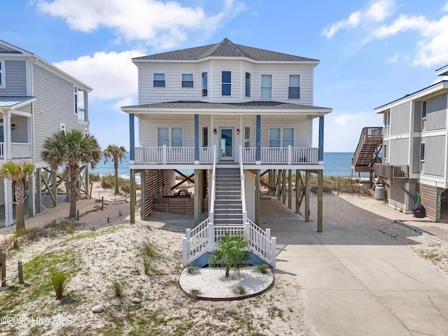 6621 W Beach Dr, Oak Island, NC 28465 - beach home featuring stairway, a carport, a porch, and driveway