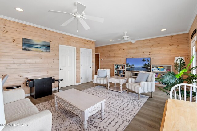 6621 W Beach Dr, Oak Island, NC 28465 - living room featuring wood walls, ceiling fan, ornamental molding, recessed lighting, and wood finished floors