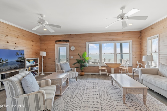 6621 W Beach Dr, Oak Island, NC 28465 - living area featuring a ceiling fan, wooden walls, recessed lighting, wood finished floors, and crown molding