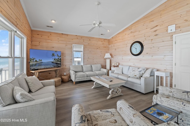 6621 W Beach Dr, Oak Island, NC 28465 - living room featuring crown molding, wood walls, healthy amount of natural light, lofted ceiling, and ceiling fan