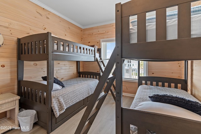 6621 W Beach Dr, Oak Island, NC 28465 - bedroom with wood walls, ornamental molding, and wood finished floors