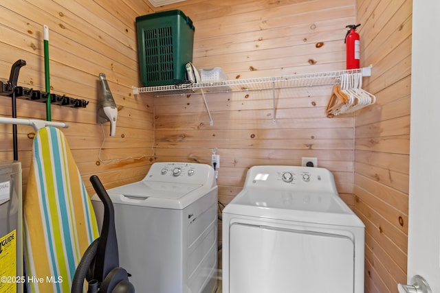 6621 W Beach Dr, Oak Island, NC 28465 - laundry area featuring washing machine and dryer and wooden walls
