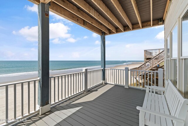 6621 W Beach Dr, Oak Island, NC 28465 - wooden terrace with view of water and beach and stairway