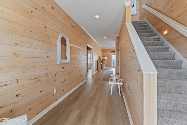 6621 W Beach Dr, Oak Island, NC 28465 - hallway featuring wooden walls, wood finished floors, recessed lighting, and stairs