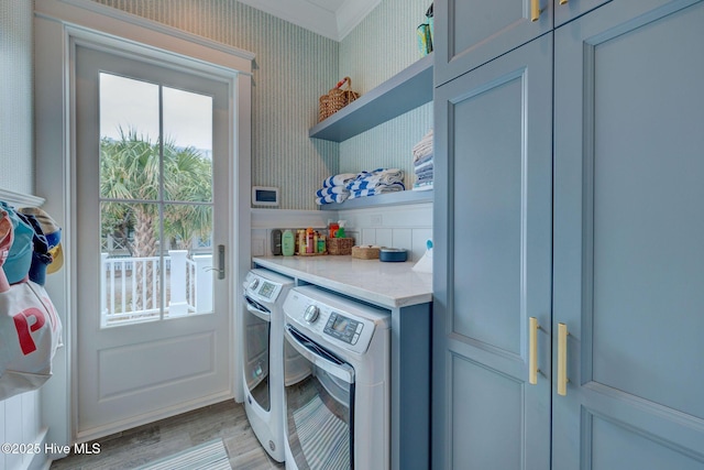 801 Federal Rd, Bald Head Island, NC 28461 - washroom featuring cabinet space, washing machine and dryer, light wood-type flooring, and wallpapered walls