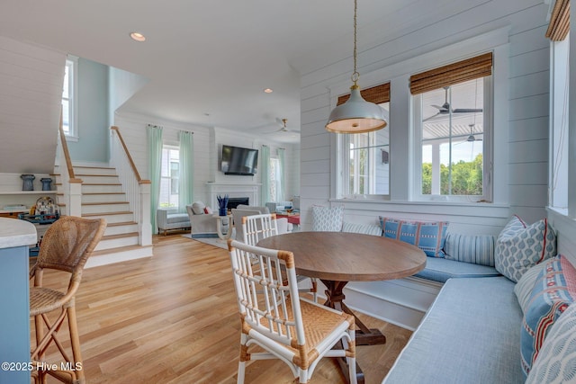 801 Federal Rd, Bald Head Island, NC 28461 - dining space with stairway, a ceiling fan, a fireplace, light wood-style floors, and recessed lighting