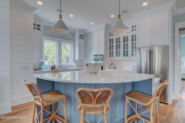 801 Federal Rd, Bald Head Island, NC 28461 - kitchen featuring appliances with stainless steel finishes, white cabinetry, light wood-style flooring, decorative backsplash, and recessed lighting