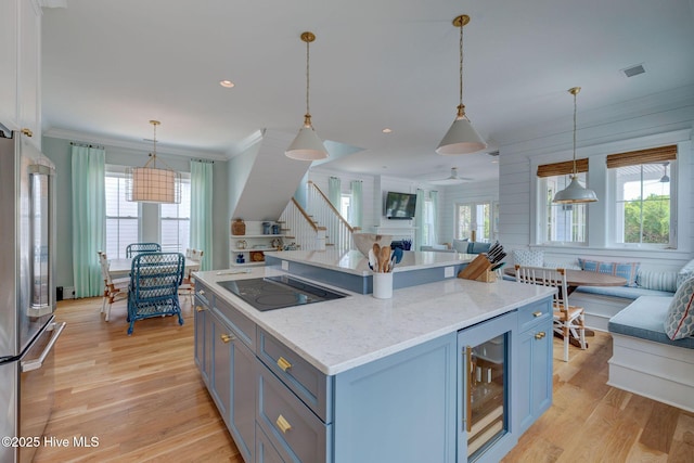801 Federal Rd, Bald Head Island, NC 28461 - kitchen with beverage cooler, black electric cooktop, open floor plan, stainless steel fridge, and light wood finished floors