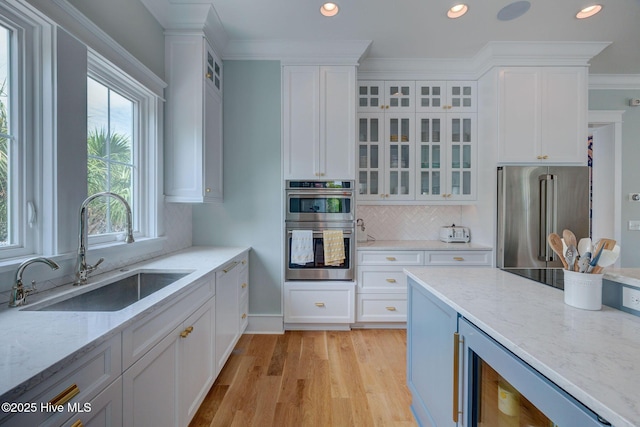 801 Federal Rd, Bald Head Island, NC 28461 - kitchen featuring stainless steel appliances, a sink, white cabinets, light wood-type flooring, and recessed lighting