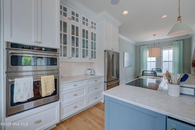 801 Federal Rd, Bald Head Island, NC 28461 - kitchen with stainless steel appliances, ornamental molding, pendant lighting, glass insert cabinets, and white cabinetry