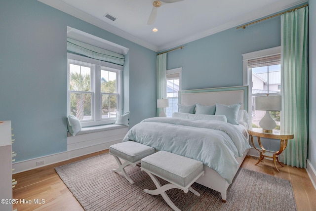 801 Federal Rd, Bald Head Island, NC 28461 - bedroom featuring multiple windows, ornamental molding, wood finished floors, baseboards, and ceiling fan