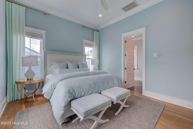 801 Federal Rd, Bald Head Island, NC 28461 - bedroom featuring crown molding, multiple windows, wood finished floors, baseboards, and a ceiling fan