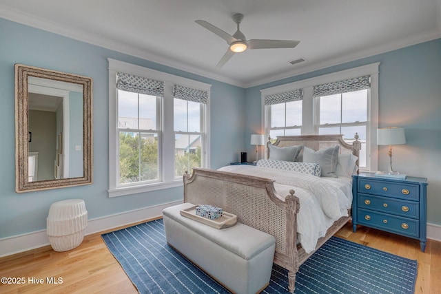 801 Federal Rd, Bald Head Island, NC 28461 - bedroom with multiple windows, crown molding, wood finished floors, baseboards, and a ceiling fan