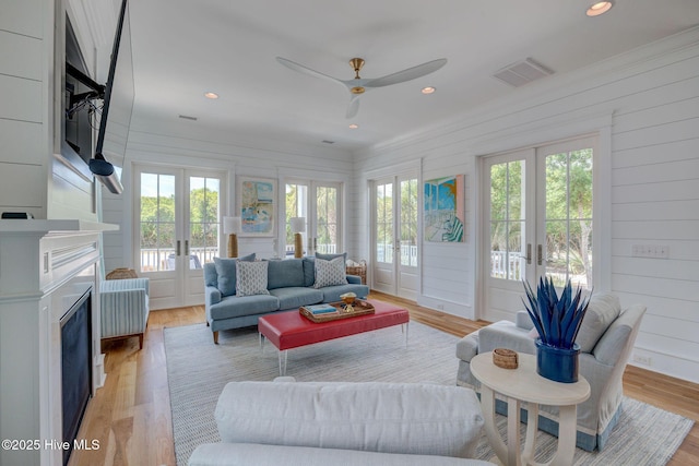 801 Federal Rd, Bald Head Island, NC 28461 - living room featuring french doors, plenty of natural light, a ceiling fan, light wood-type flooring, and ornamental molding