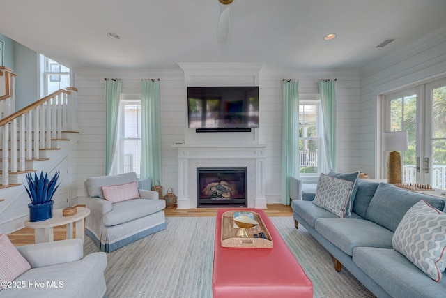 801 Federal Rd, Bald Head Island, NC 28461 - living area with a glass covered fireplace, stairs, wood finished floors, wood walls, and recessed lighting
